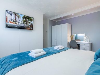 A bedroom with a bed and television at The Old Barn in Manchester