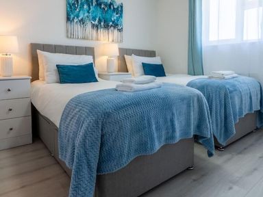 A bedroom with two beds and nightstands at The Old Barn in Manchester