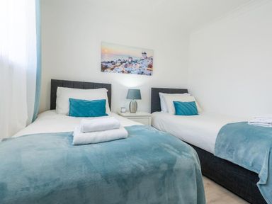 A bedroom with two beds and a bedside table at the property in location