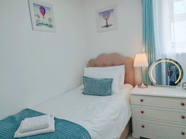 A bedroom with a single bed and a dresser at The Old Barn in Manchester