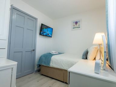 A bedroom with a bed and TV at The Old Barn in Manchester