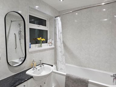 A bathroom with a bathtub and sink at 