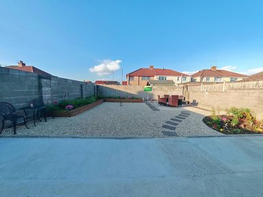 A garden with gravel and seating area at a residential property