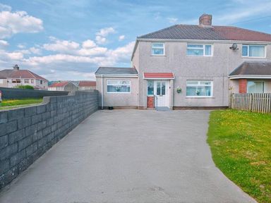 A house with a driveway and garden at an unspecified location