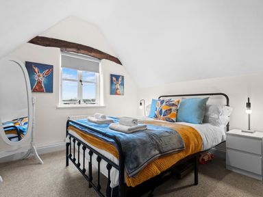 A bedroom with a bed and a mirror at The Old Barn in Manchester