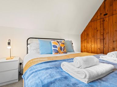 A bedroom with a bed and pillows at the property in location