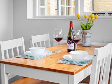 A dining room with a table set for two at The Old Barn in Manchester