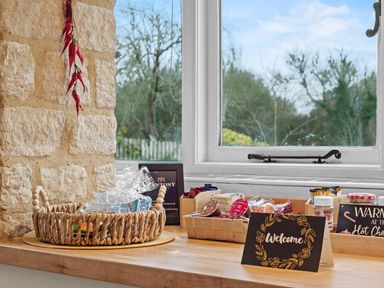 A kitchen counter with a basket and snacks at The Old Barn in Manchester