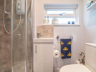 A bathroom with shower and sink at The Old Barn in Manchester