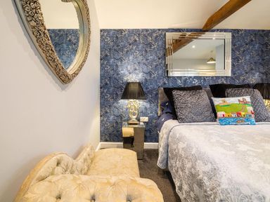 A bedroom with a bed and decorative elements at the property
