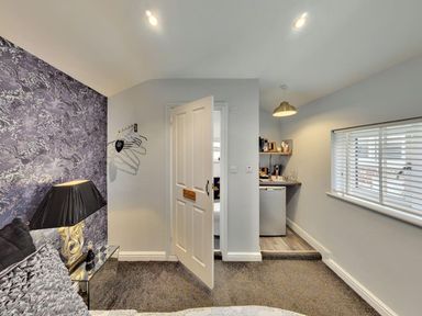 A bedroom with a kitchenette and a door leading outside at the property in location