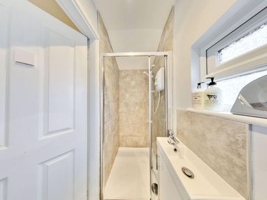 A bathroom with a shower, toilet, and sink at The Old Barn in Manchester