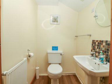 A bathroom with a toilet and sink at Bryn Eithin in Penygroes