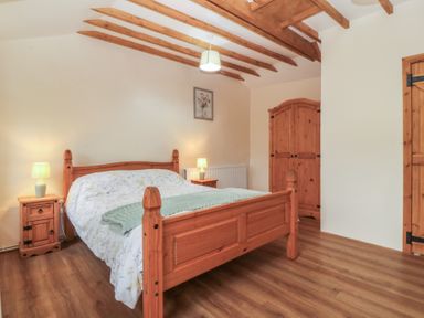 A bedroom with a bed and bedside table at Bryn Eithin in Penygroes