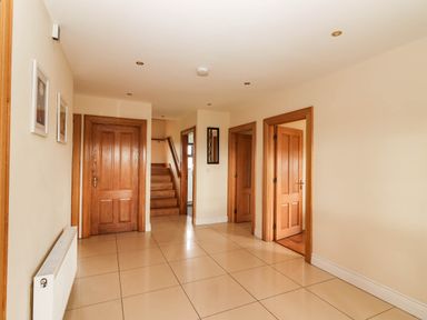 A hallway with doors and a staircase at Wild Atlantic Ferry View in Kilrush, County Clare