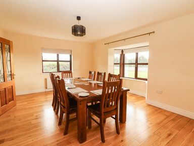 A dining room with a table and chairs at Wild Atlantic Ferry View in Kilrush, County Clare