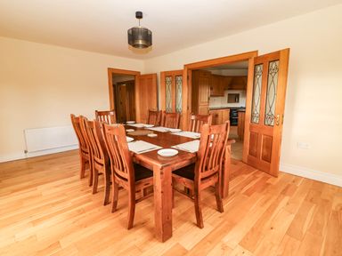 A dining room with a large table and chairs at Wild Atlantic Ferry View, Kilrush, County Clare