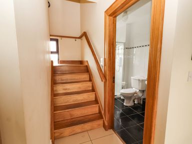 A stairway leading to a bathroom with a toilet and shower at Wild Atlantic Ferry View, Kilrush, County Clare