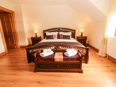 A bedroom with a bed and nightstand at Wild Atlantic Ferry View, Kilrush, County Clare
