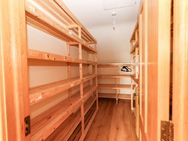 A closet with wooden shelves and hangers at Wild Atlantic Ferry View, Kilrush, County Clare