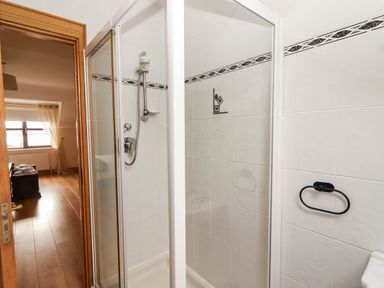 A bathroom with a shower and towel holder at Wild Atlantic Ferry View, Kilrush, County Clare