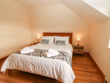 A bedroom with a bed and bedside tables at Wild Atlantic Ferry View, Kilrush, County Clare