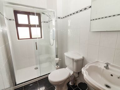 A bathroom with shower, toilet, and sink at Wild Atlantic Ferry View, Kilrush, County Clare
