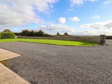 An outdoor area with gravel and grass at Wild Atlantic Ferry View, Kilrush, County Clare