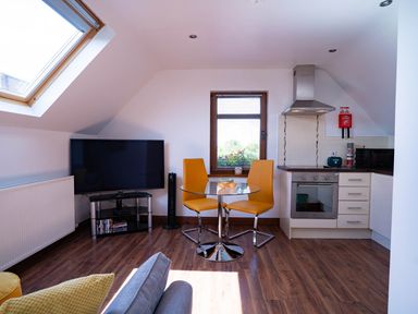 A kitchen with a dining table and chairs at Limavady Cherry Tree Apartment, Sleeps 2 and Parking Limavady