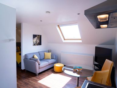 A living room with a sofa and coffee table at Limavady Cherry Tree Apartment, Sleeps 2 and Parking, Limavady