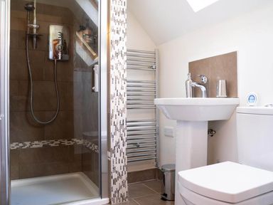 A bathroom with a shower, sink, and toilet at Limavady Cherry Tree Apartment, Sleeps 2 and Parking, Limavady