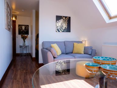 A living room with a sofa and coffee table at Limavady Cherry Tree Apartment, Sleeps 2 and Parking in Limavady