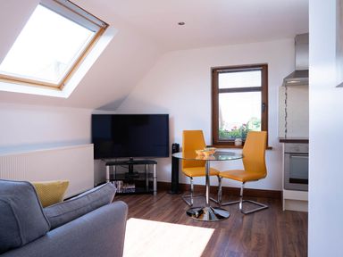 A living room with a television and seating area at Limavady Cherry Tree Apartment, Sleeps 2 and Parking Limavady