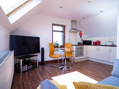A kitchen area with a table and chairs at Limavady Cherry Tree Apartment, Sleeps 2 and Parking Limavady