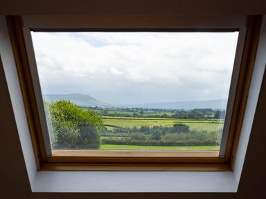 A view from a window showing fields and mountains at Limavady Cherry Tree Apartment, Sleeps 2 and Parking in Limavady