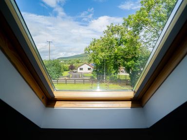 A view of a house and trees from a window at Limavady Cherry Tree Apartment, Sleeps 2 and Parking, Limavady