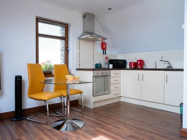 A kitchen with a table and chairs at Limavady Cherry Tree Apartment, Sleeps 2 and Parking in Limavady