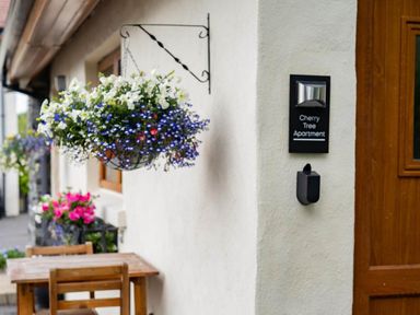 An entrance with a door and a sign for Cherry Tree Apartment in Limavady