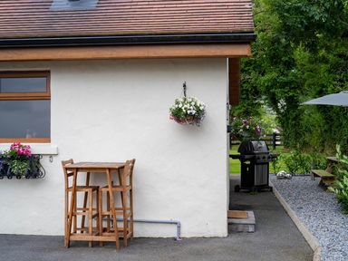 A bar height table with stools and a grill at Limavady Cherry Tree Apartment, Sleeps 2 and Parking in Limavady