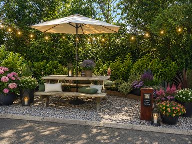 A garden with a wooden table and umbrella at Limavady Cherry Tree Apartment, Sleeps 2 and Parking, Limavady