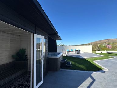 An outdoor area with a hot tub and seating at Jeannies retreat at little lake fb