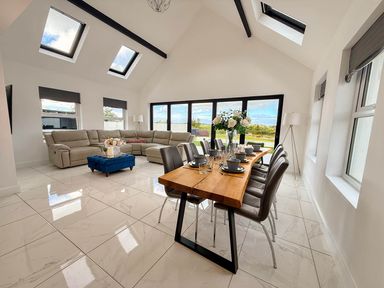 A living room with a sofa and dining area at Jeannies retreat at little lake fb