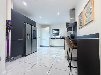 A kitchen with appliances and seating at Jeannies retreat at little lake fb