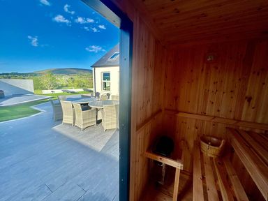 A sauna with wooden benches and a view of outdoor seating at Jeannies retreat at little lake fb