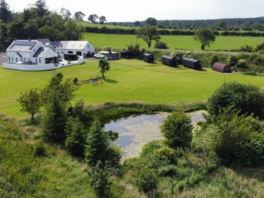 An outdoor view of a house and garden at Jeannies retreat at little lake fb