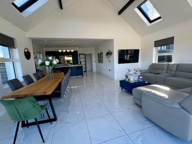 A living room with a dining area and kitchen island at Jeannies retreat at little lake fb
