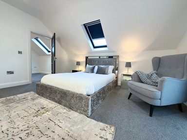 A bedroom with a bed, armchair and skylights at Jeannies retreat at little lake fb