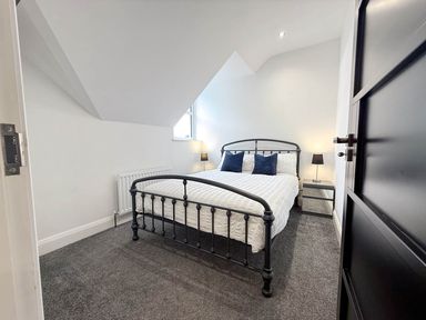 A bedroom with a bed and bedside table at Jeannies retreat at little lake fb