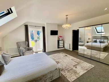 A bedroom with a bed and an armchair at Jeannies retreat at little lake fb