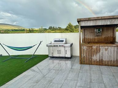 An outdoor area with a grill and hammock at Jeannies retreat at little lake fb